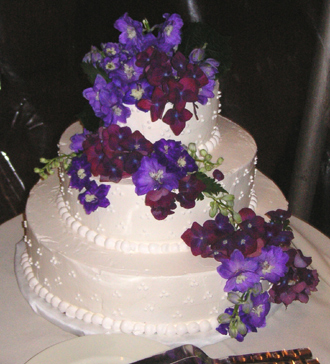 Wedding Photos on Wedding Cake With Purple Flowers   Elegant Eating   Long Island New